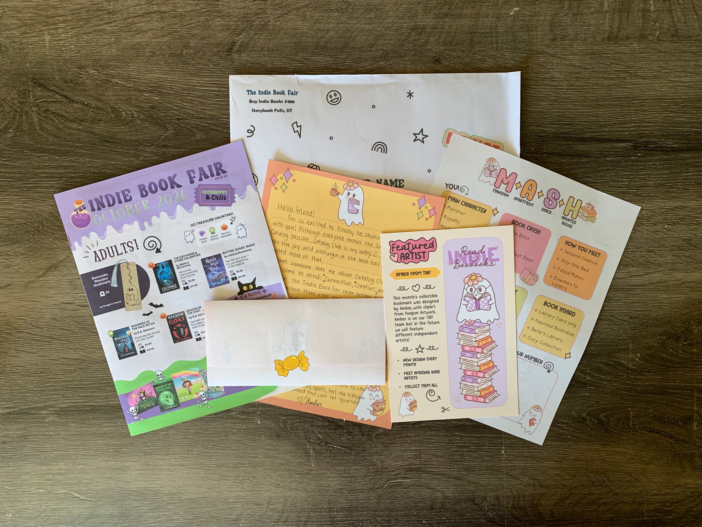 A flat lay of books, paper, and a tote from The Indie Book Fair Catalog